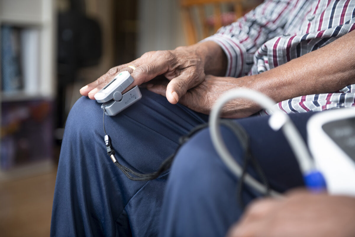 Man having his blood pressure and blood saturation levels measured