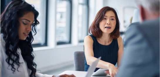 Woman discussing with colleagues at table