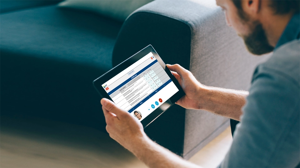 Man holding a tablet displaying eCOA Live