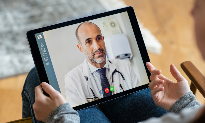 Person making video call with a healthcare professional from home